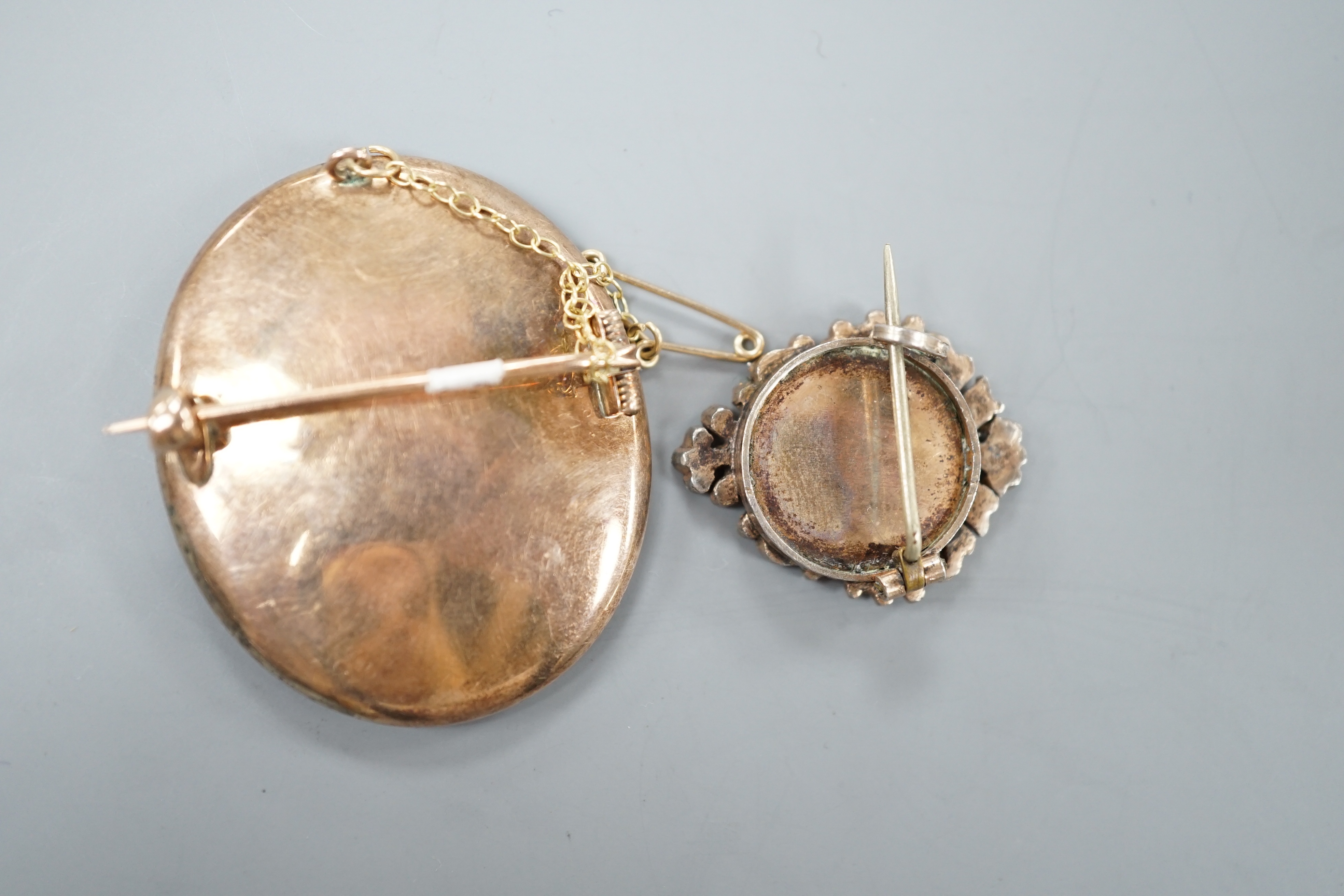 A Victorian yellow and white metal and paste set oval miniature brooch, 41mm and a small circular seed pearl set miniature brooch.